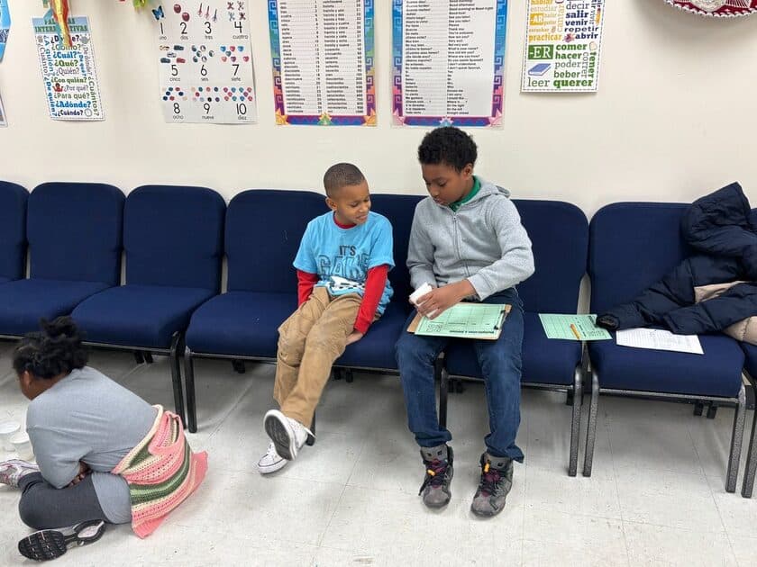Two middle school students reviewing a worksheet together in Spanish class